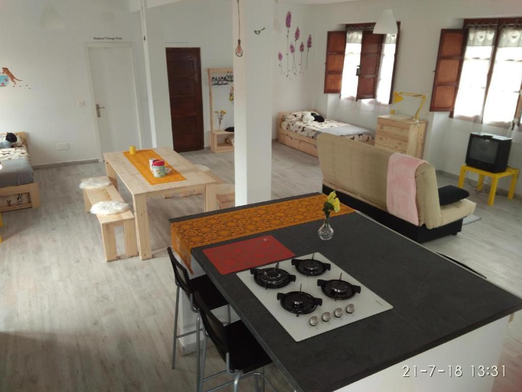 a kitchen and a living room with a stove top at Casa Piedad in Allence
