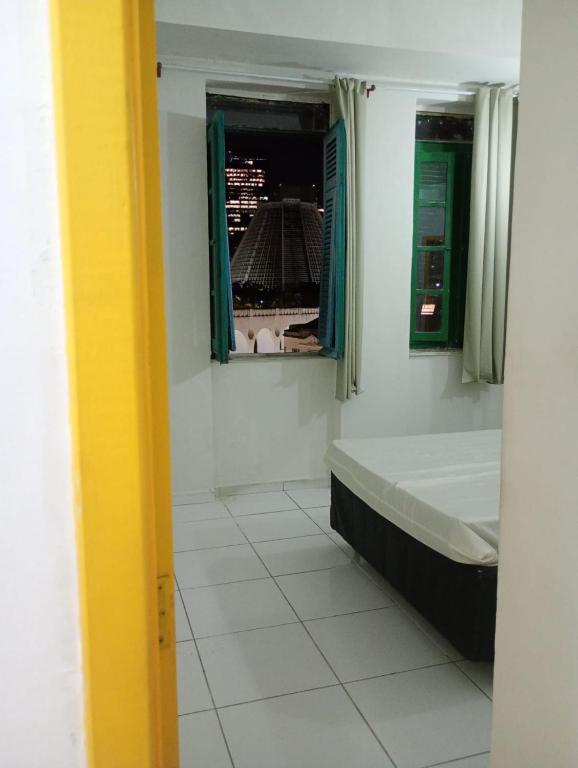 a bathroom with a bath tub and a window at Boêmia carioca in Rio de Janeiro