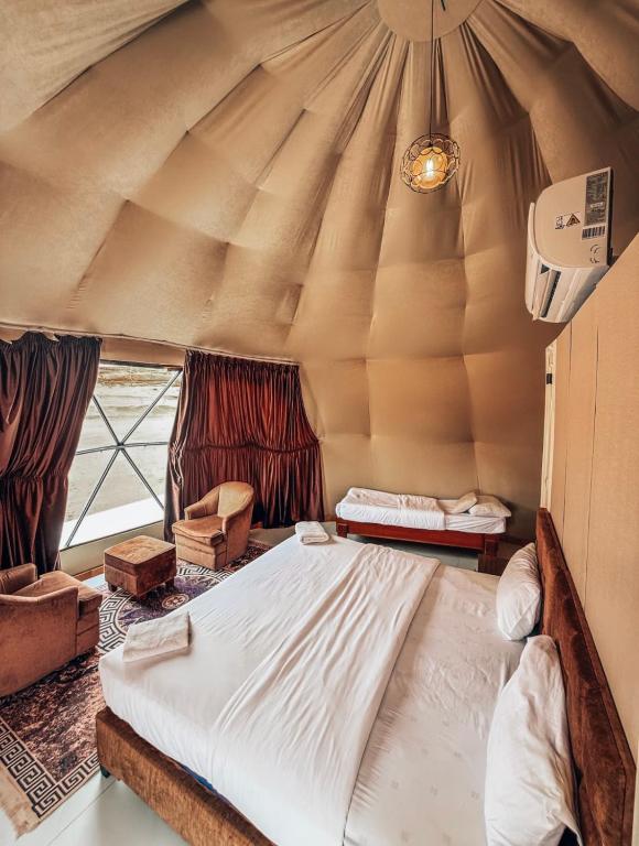 a bedroom with a large bed in a tent at Eileen wadi rum camp in Wadi Rum