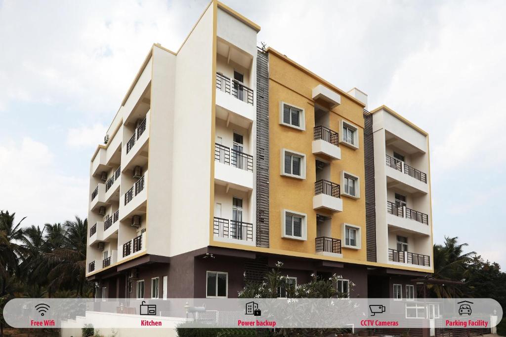 a building with balconies on the side of it at Hotel O Indra Comforts in Belagula