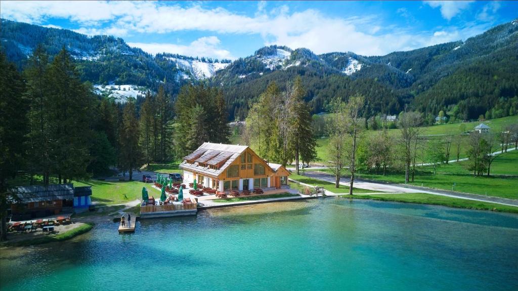 an aerial view of a house in the middle of a lake at Gostišče Jezersko in Zgornje Jezersko