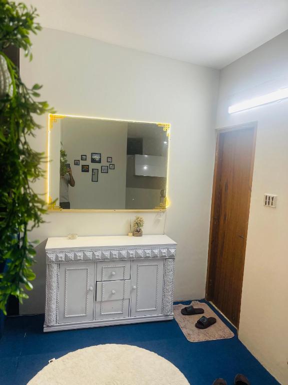 a bathroom with a mirror and a white sink at Hillcrest Terraces Bhurban in Rāwāt