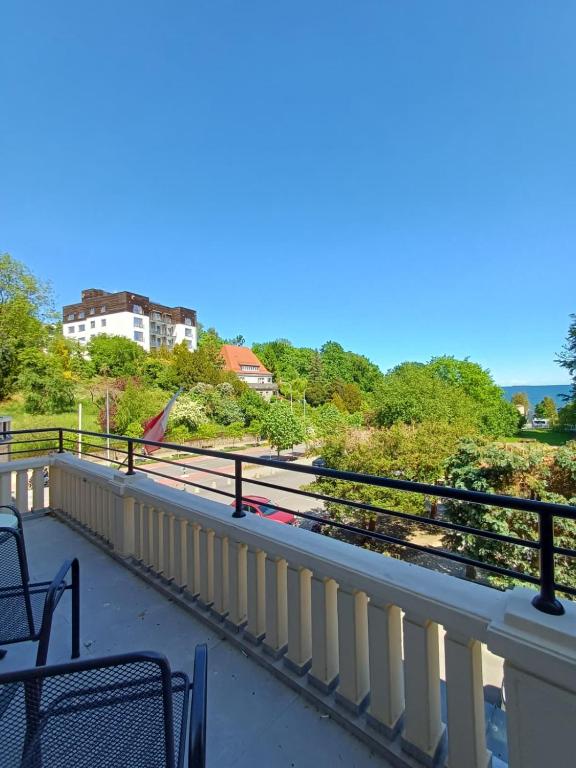 a balcony with chairs and a view of a building at Hotel Dom Marynarza in Gdynia