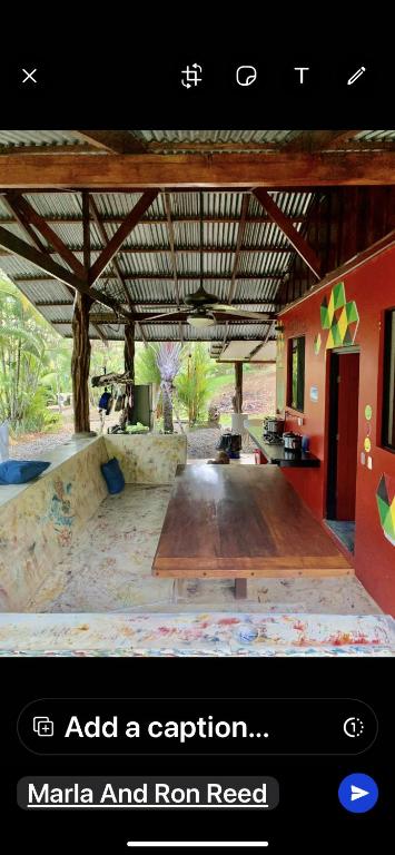 an image of a room with a large wooden table at Dolphin Quest Apartment #1 in Pavones