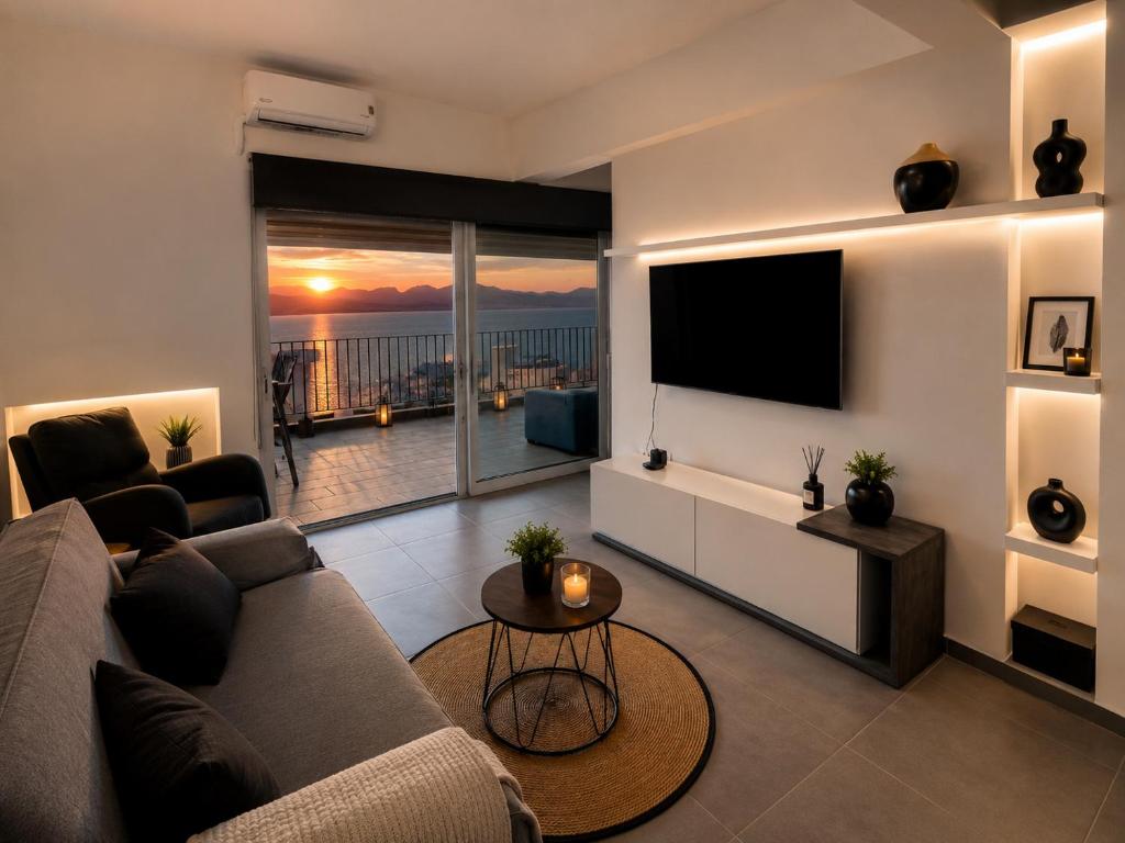 a living room with a couch and a flat screen tv at Minimal Panorama Loutraki in Loutraki