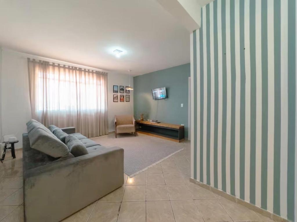 a living room with a couch and a table at Apartamento amplo e confortável 1 in Maringá
