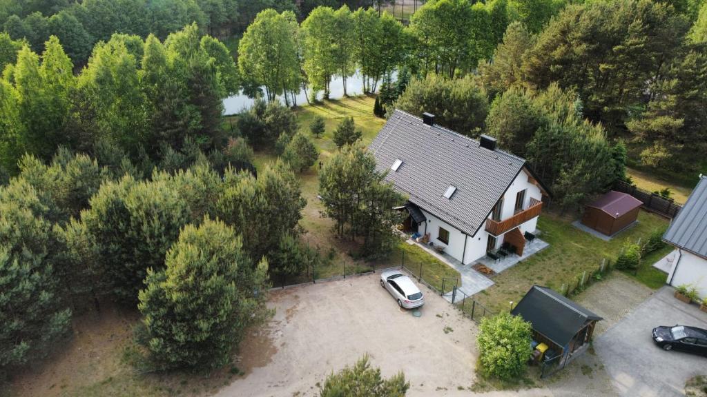 an aerial view of a house with a car parked in a yard at Strumykowa 3 in Swornegacie