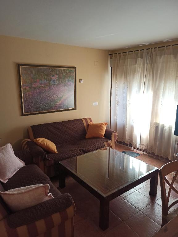 a living room with a couch and a coffee table at La Ribera del Río in Trefacio