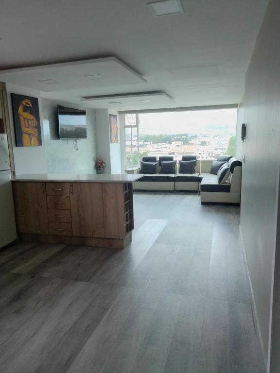 a large living room with a couch and a table at HOSPEDAJE YACUCALLE in Ibarra