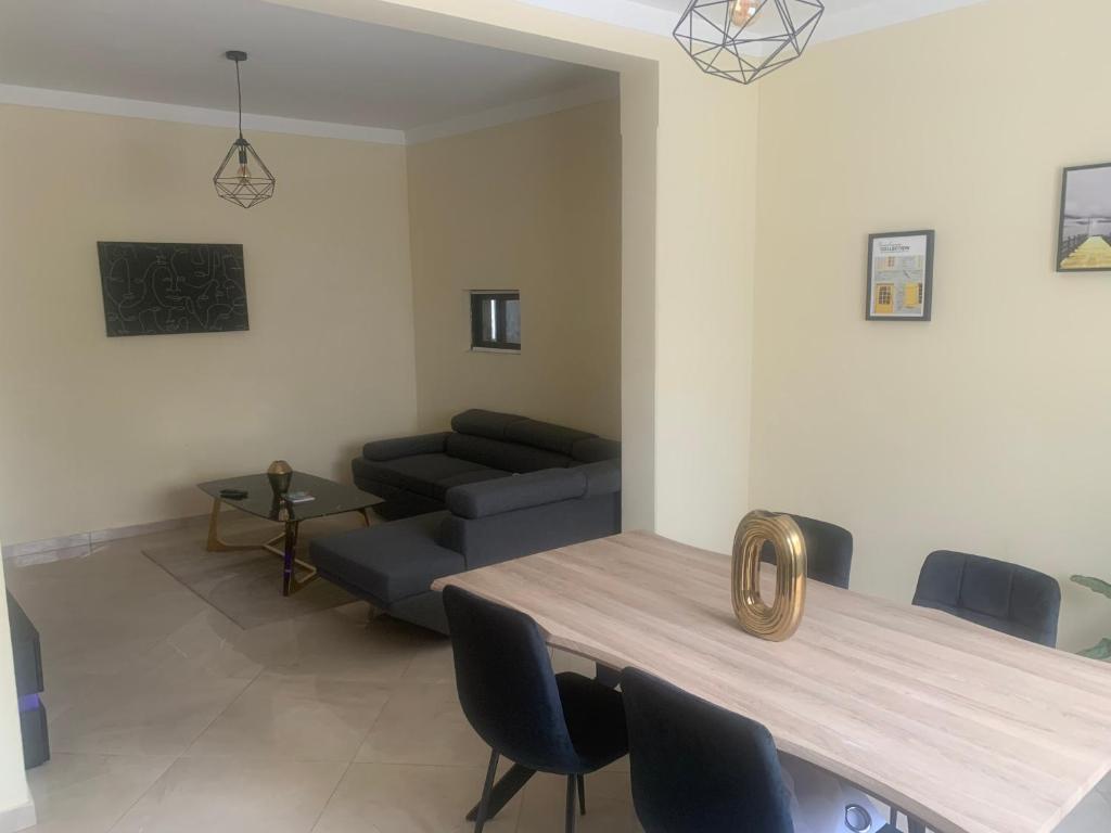 a living room with a table and a couch at Beautiful 2-bedroom apartment in Assomada