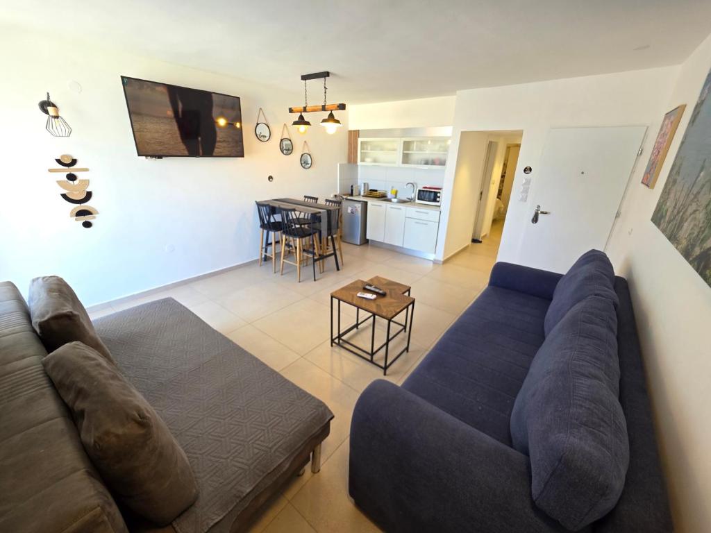 a living room with a couch and a table at Lev Eilat Suites in Eilat
