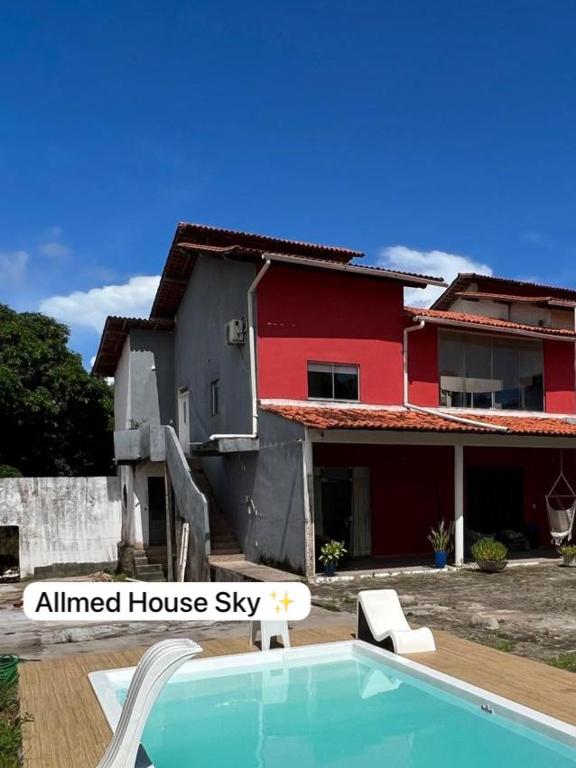 a house and a swimming pool in front of a house at Recanto Tranquilo - Espaço amplo e completo - Sky in São Luís