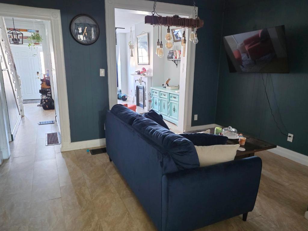 a living room with a blue couch and a table at Vintage Home Vibe in Jersey City