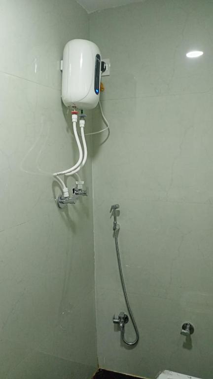 a bathroom with a toilet and a water tank at Munot residency in Manmād