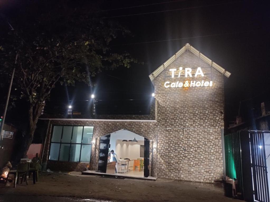 a building with a sign that reads tra cafe and kitchen at Tira Hotel and Cafe in Rudraprayāg
