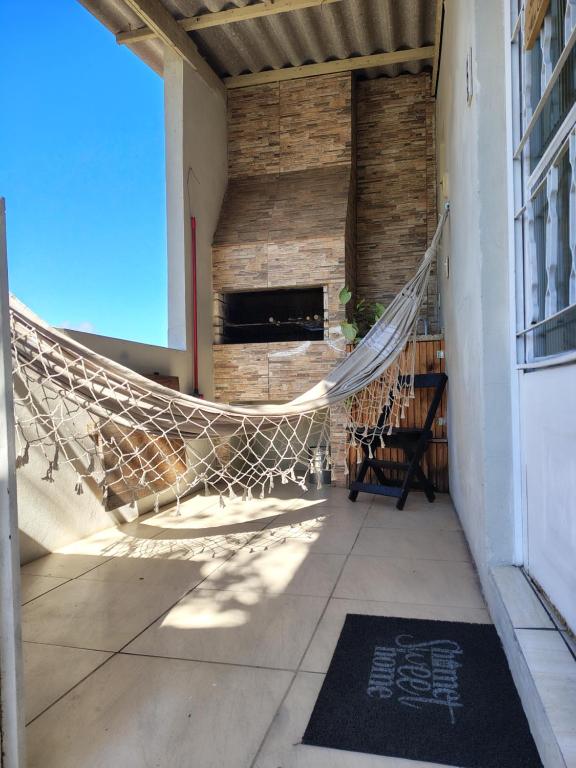 a hammock on the porch of a building at Condomínio Central Meu Cantinho in Uruguaiana