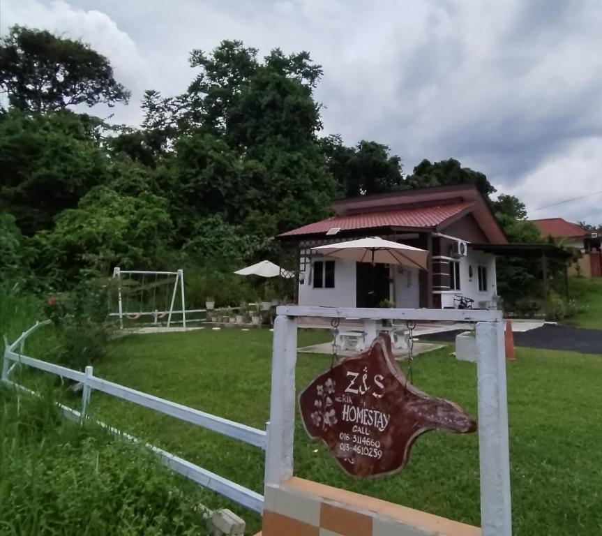 a sign in front of a dog house at Z&S Gerik Hillview Homestay in Gerik