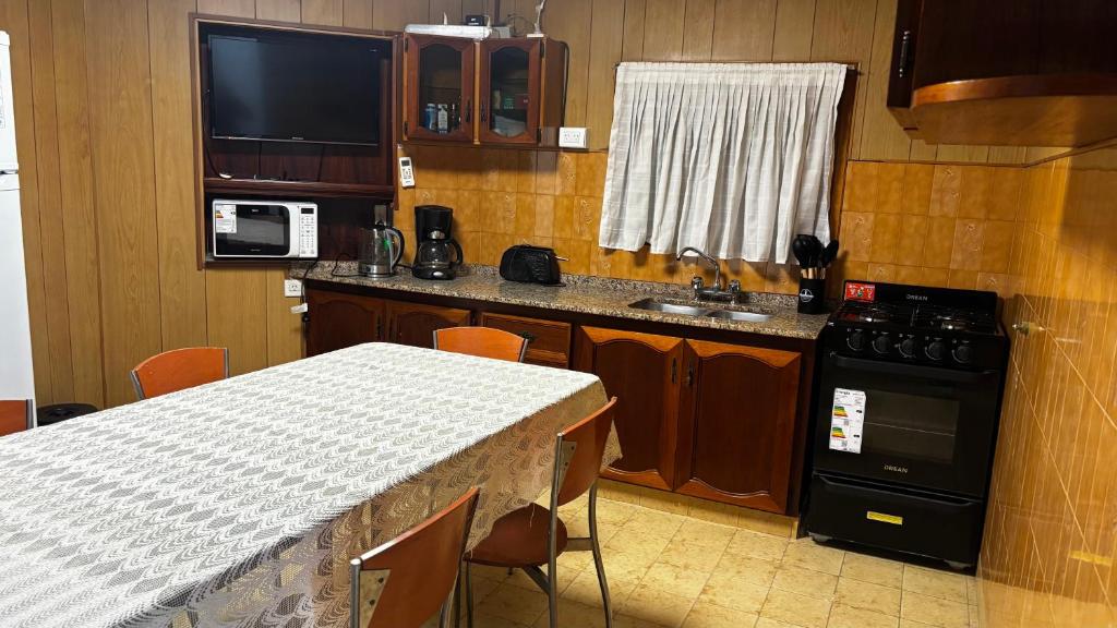 a small kitchen with a table and a counter top at Soles del Boulevard in Córdoba