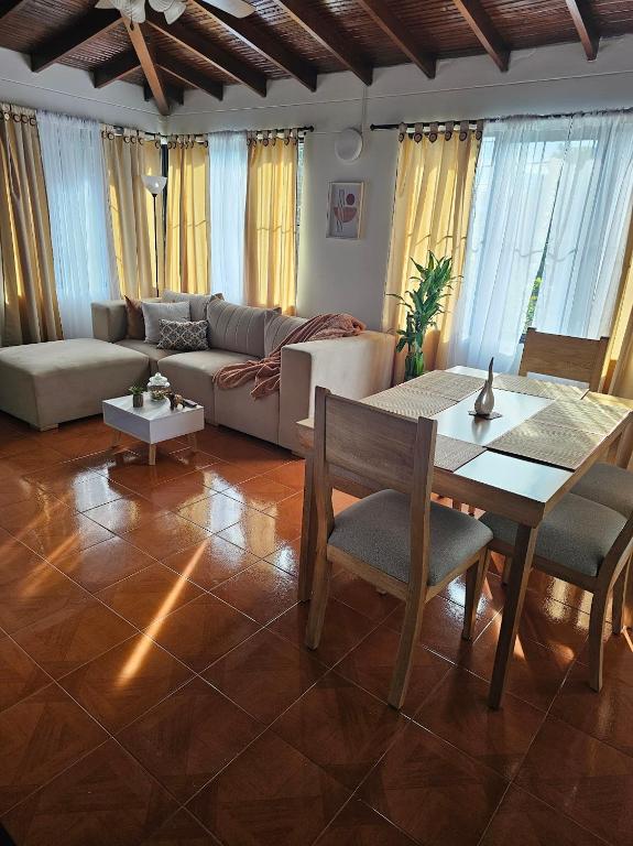 a living room with a couch and a table at Casa luz in Medellín