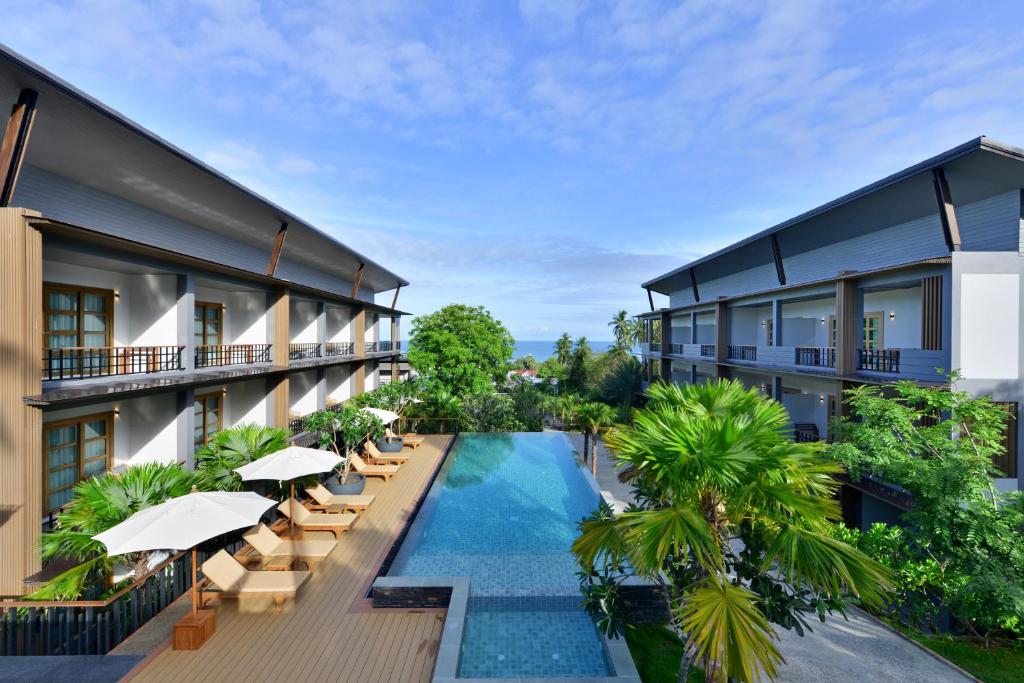 an aerial view of a resort with a swimming pool and chairs at Seacrest Boutique Kohtao Thailand in Ko Tao