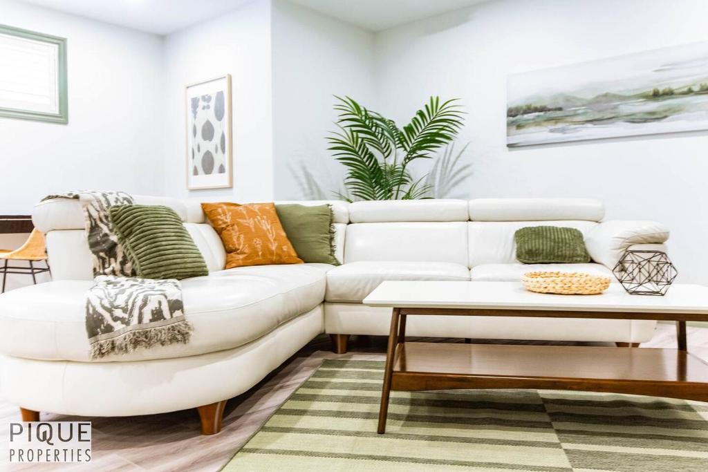 a living room with a white couch and a table at Spacious Bright Suite - Sleeps 4 - King Bed - NFLX in Edmonton