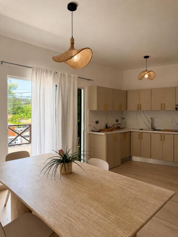 a kitchen with a table and a dining room at My tropical home in La Laguna