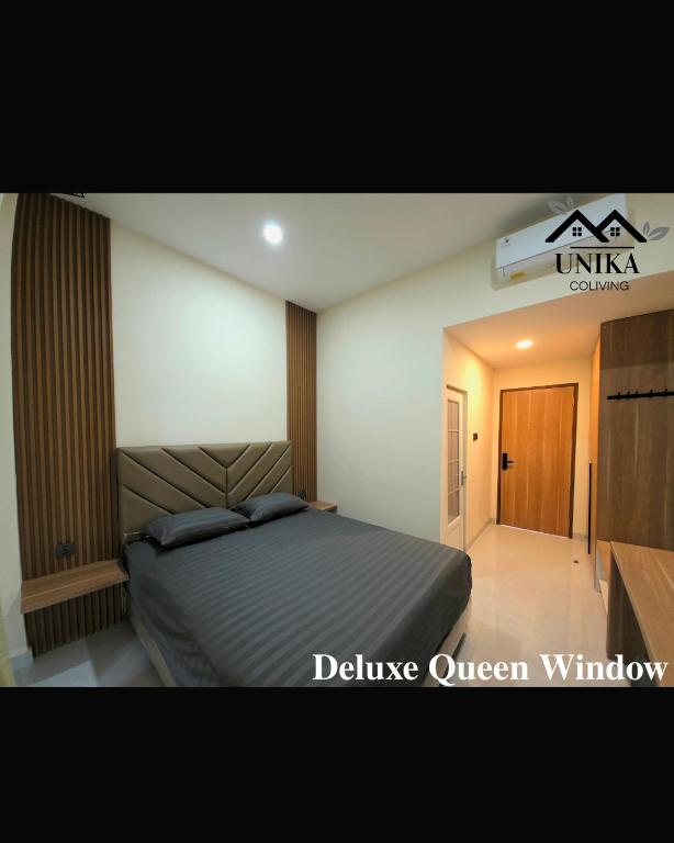 a bedroom with a bed in a room at Unika Coliving Vibes Syariah in Sultan Syarif Kasim II International Airport