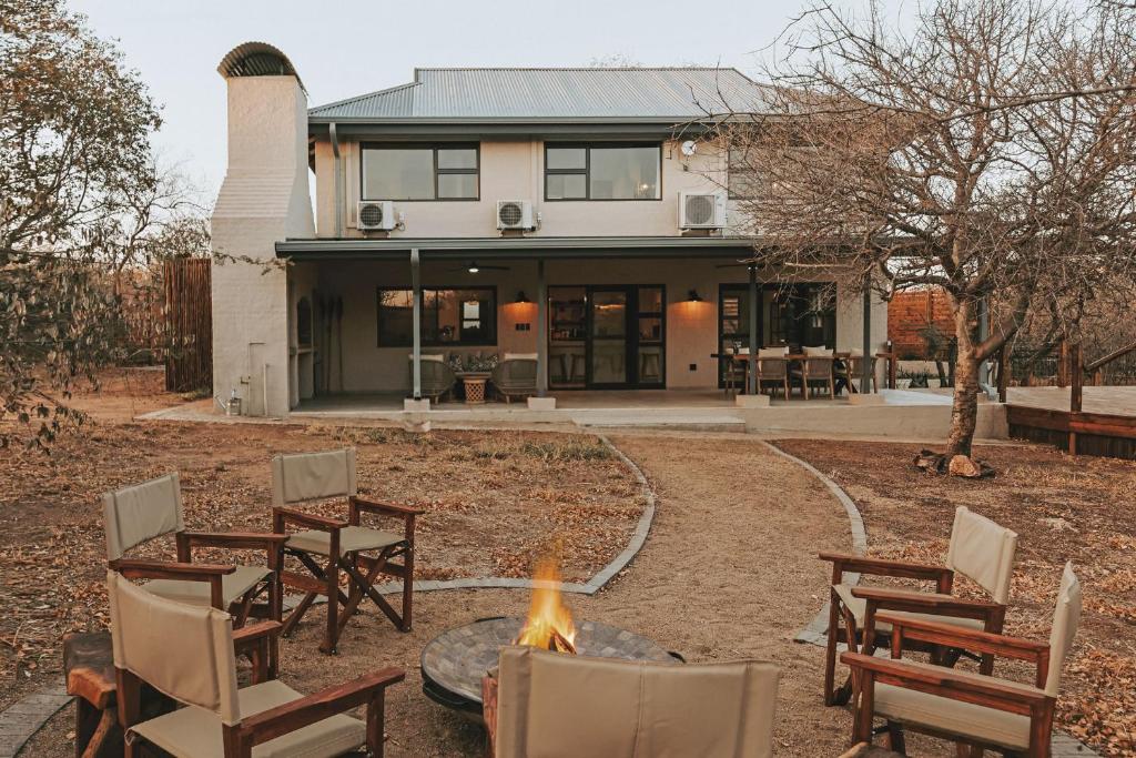 a fire pit in front of a house at Lala Lodge in Hoedspruit