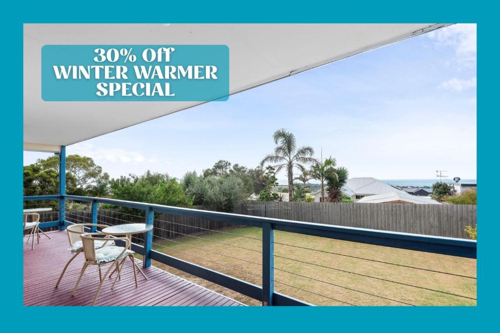 awning over a deck with a table and chairs at Bay View in Portarlington