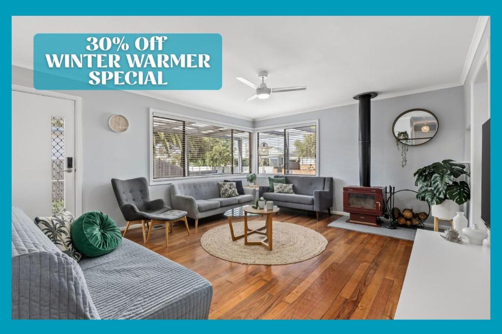 a living room with a couch and a table at Bellarine Beach Shack in Saint Leonards