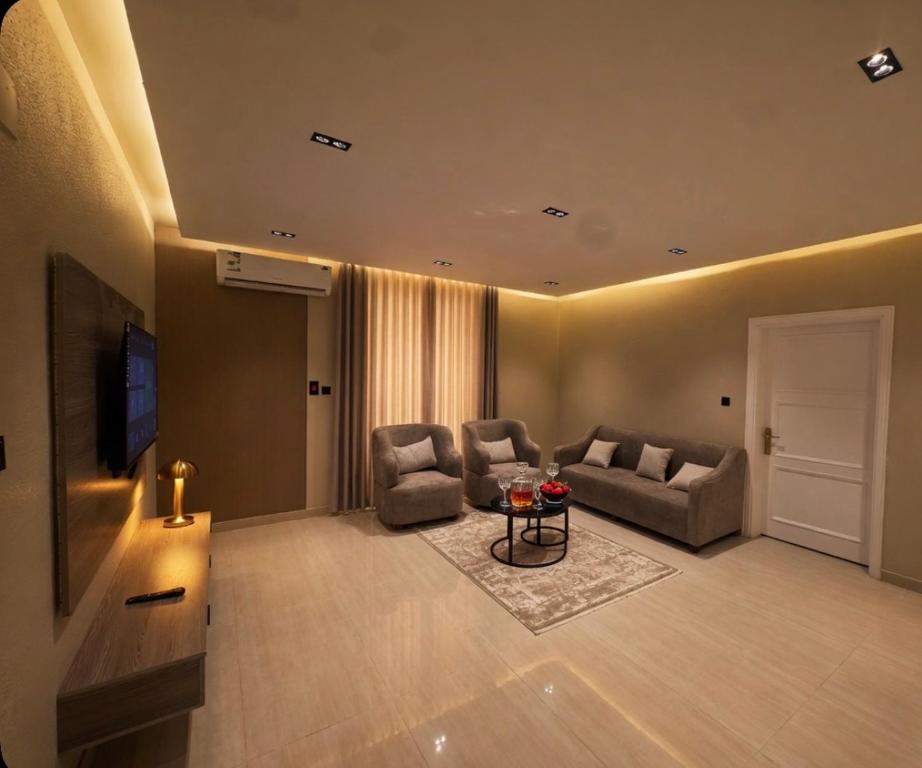 a living room with a couch and chairs and a table at Bluestone Amlak 1 in Medina
