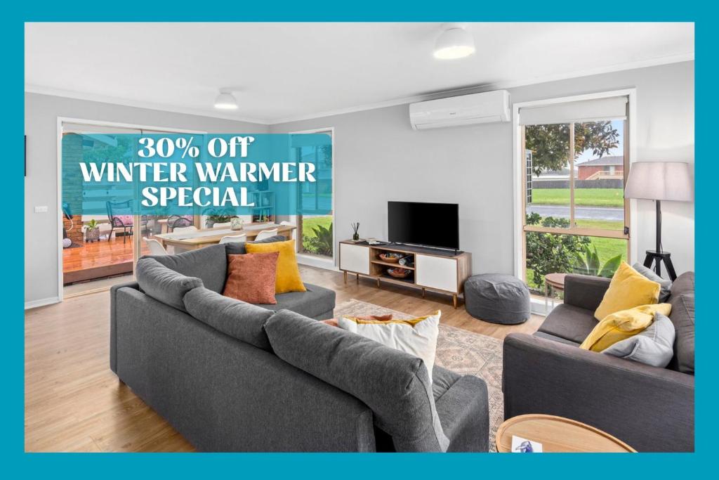 a living room with two couches and a sign that reads winter warmer special at Parrwang Rest in Portarlington