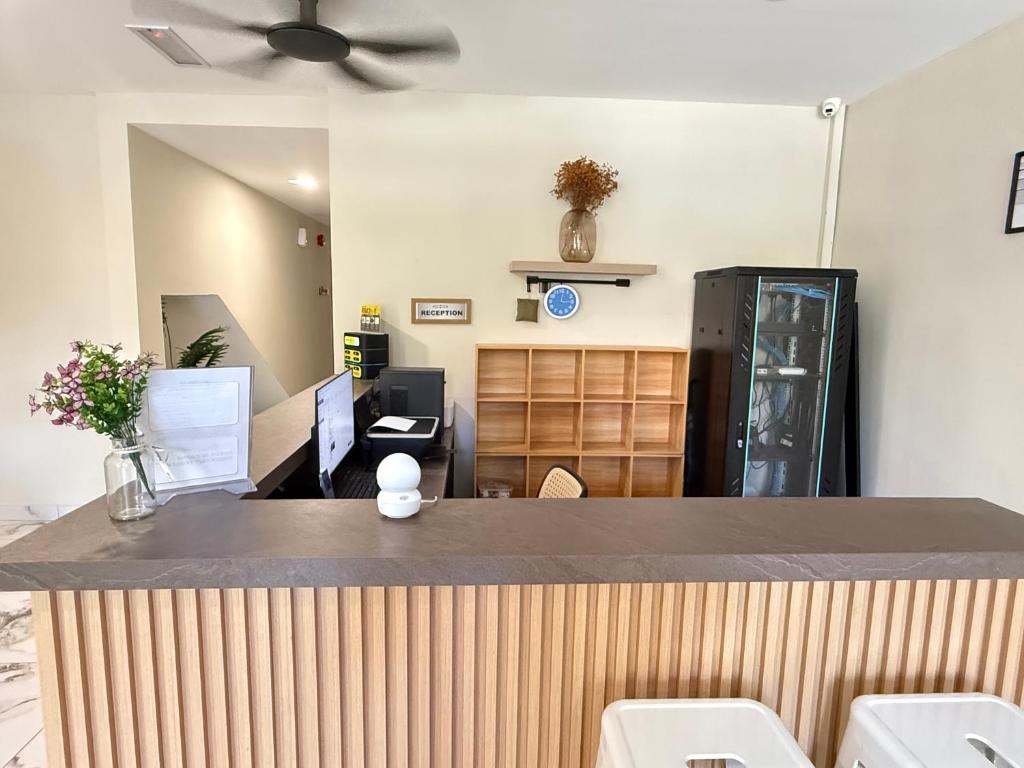 an office with a reception desk with a ceiling fan at Apex Hotel by Setapak Central in Kuala Lumpur