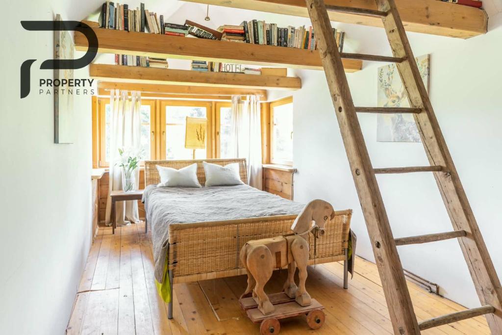 a room with a bunk bed and a ladder at Góralski relaks in Dzianisz