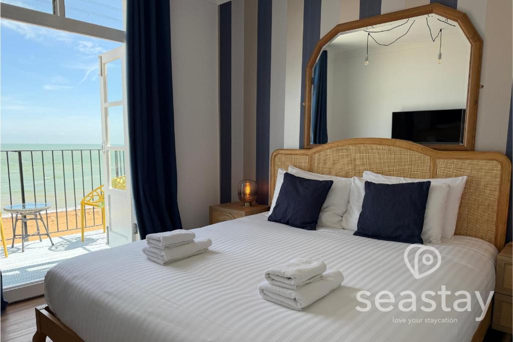 a bedroom with a large bed with towels on it at Beach Lookout Direct Access to Viking Bay Sleeps 4 in Kent