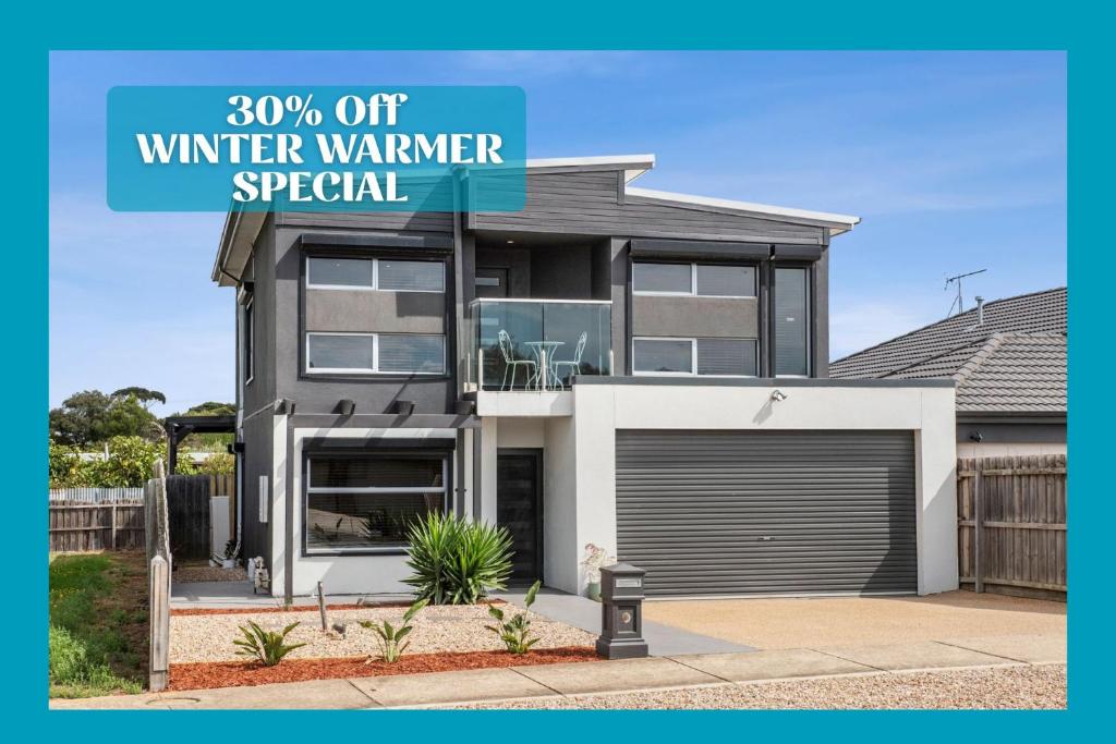 a house with a sign that reads off winter warmer special at Tranquil Turnberry in Saint Leonards