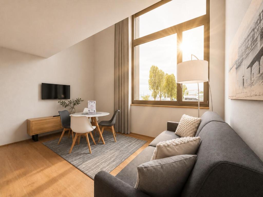a living room with a couch and a table at LAKE-SIDE Säntisblick in Romanshorn