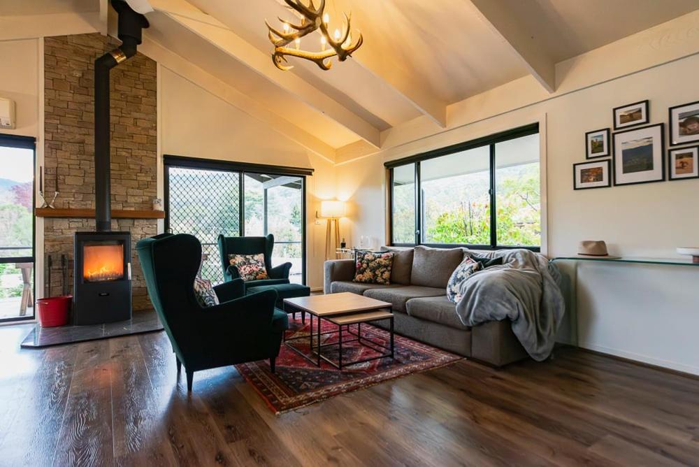 a living room with a couch and a fireplace at High Country on Perkins in Jamieson