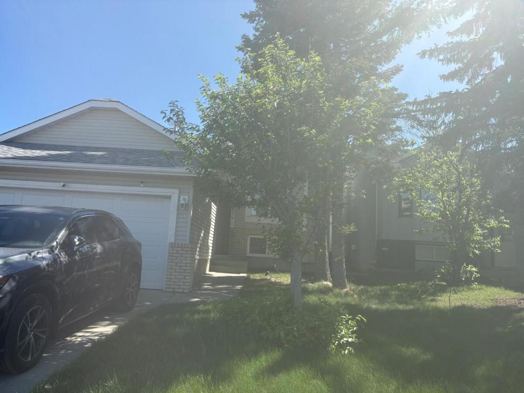 a car parked in the driveway of a house at Lower Suite- 10 minutes away from airport in Calgary