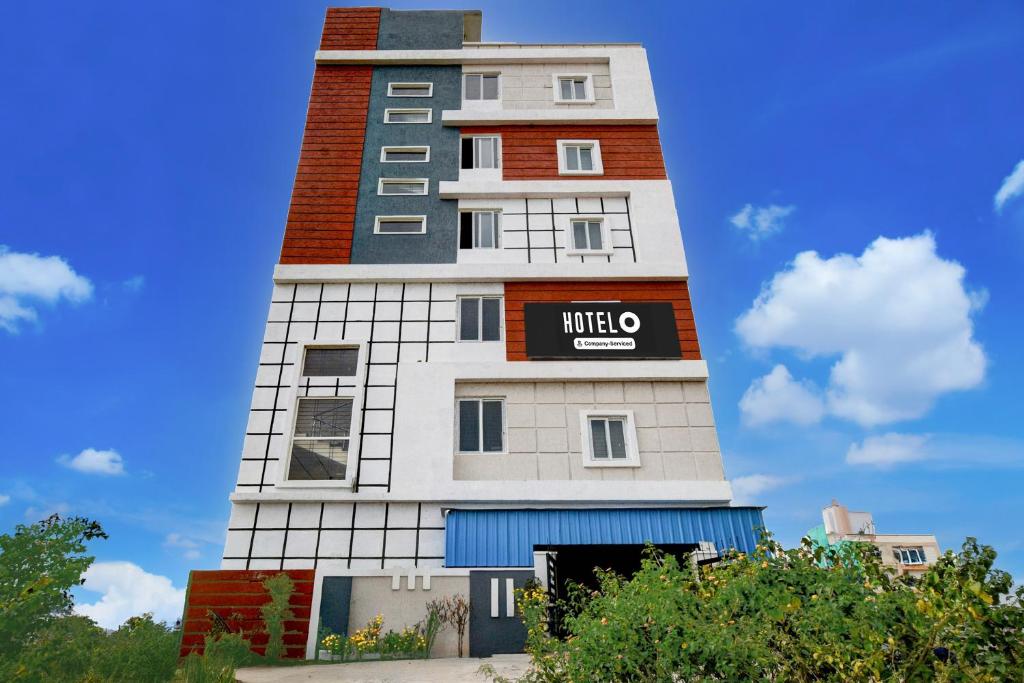 a tall building with a sign on it at Super Hotel O Bharat Institute of Engineering Hyderabad Formerly Blue Petals in Hyderabad