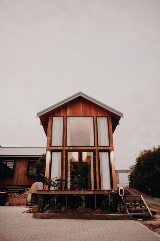 a small wooden house with a large window at View Street Studios - Yarri in Albany