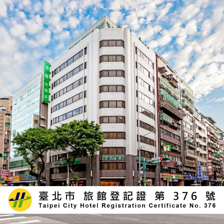 a tall white building with a sign on it at Green World Linsen in Taipei