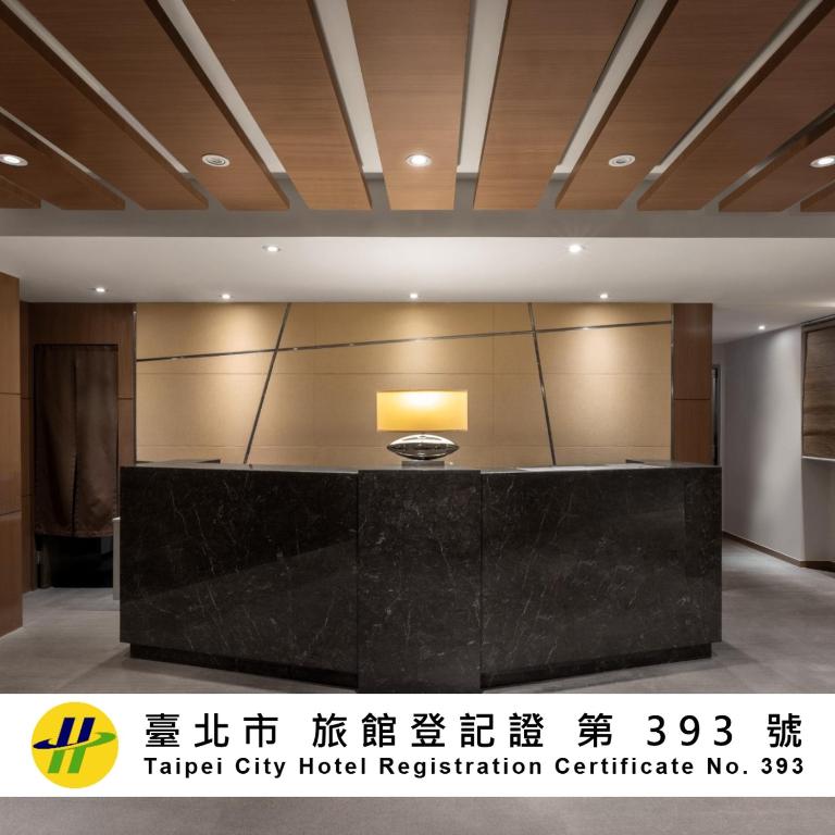 a lobby of a hotel with a reception desk at Green World Mai - NanJing in Taipei