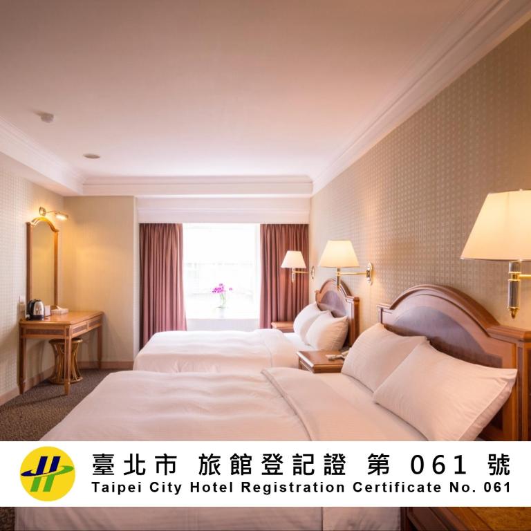 a hotel room with two beds and a window at Green World Flora Annex in Taipei