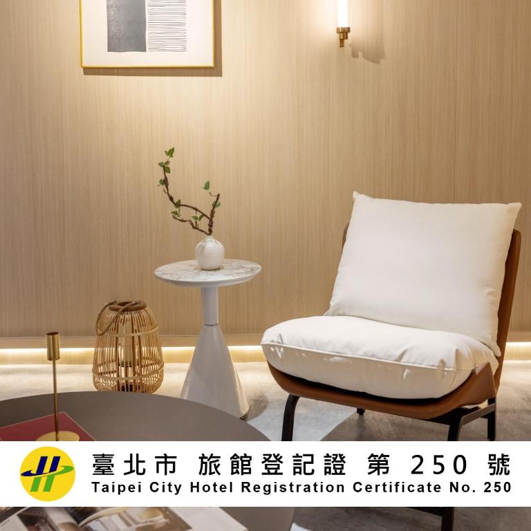 a white chair and a table in a room at New World Hotel in Taipei