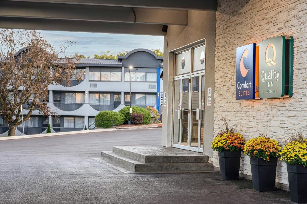 a entrance to a building with flowers in front of it at Quality Inn & Conference Centre Kingston Central in Kingston