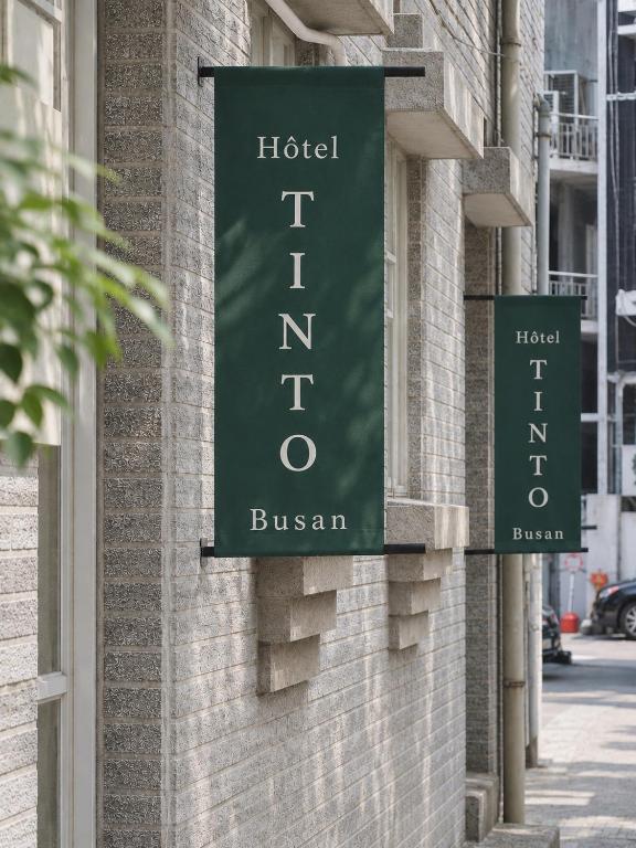 a green sign on the side of a building at Tinto Hotel Busan Station in Busan
