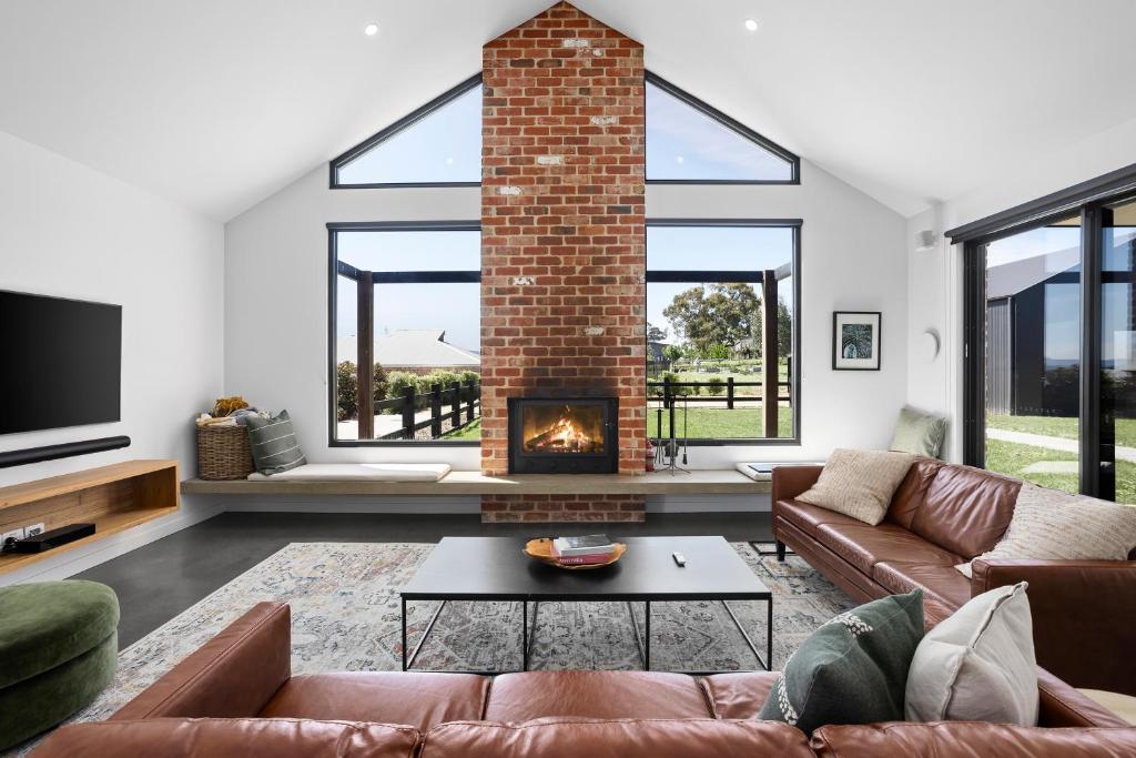 a living room with a couch and a fireplace at Wild Wombat in Mansfield