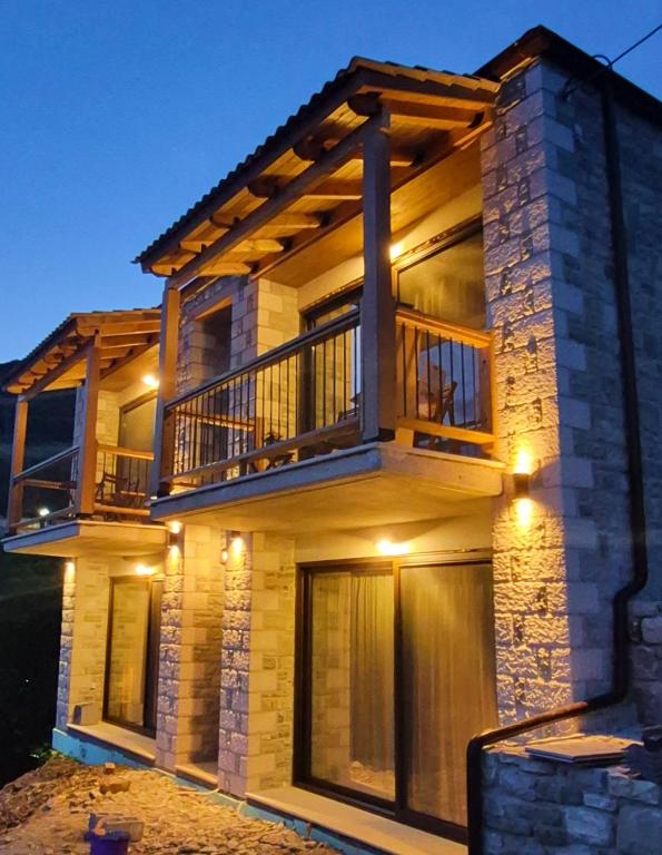 a house with a balcony on top of it at Stone Loft in Karpenisi