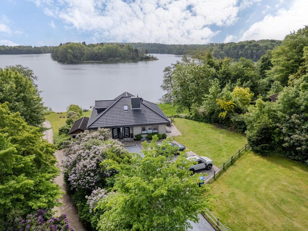an aerial view of a house next to a lake at Haus am See in Stocksee